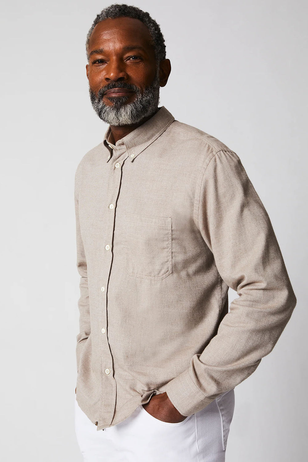 Man wearing a tan long sleeved button up
