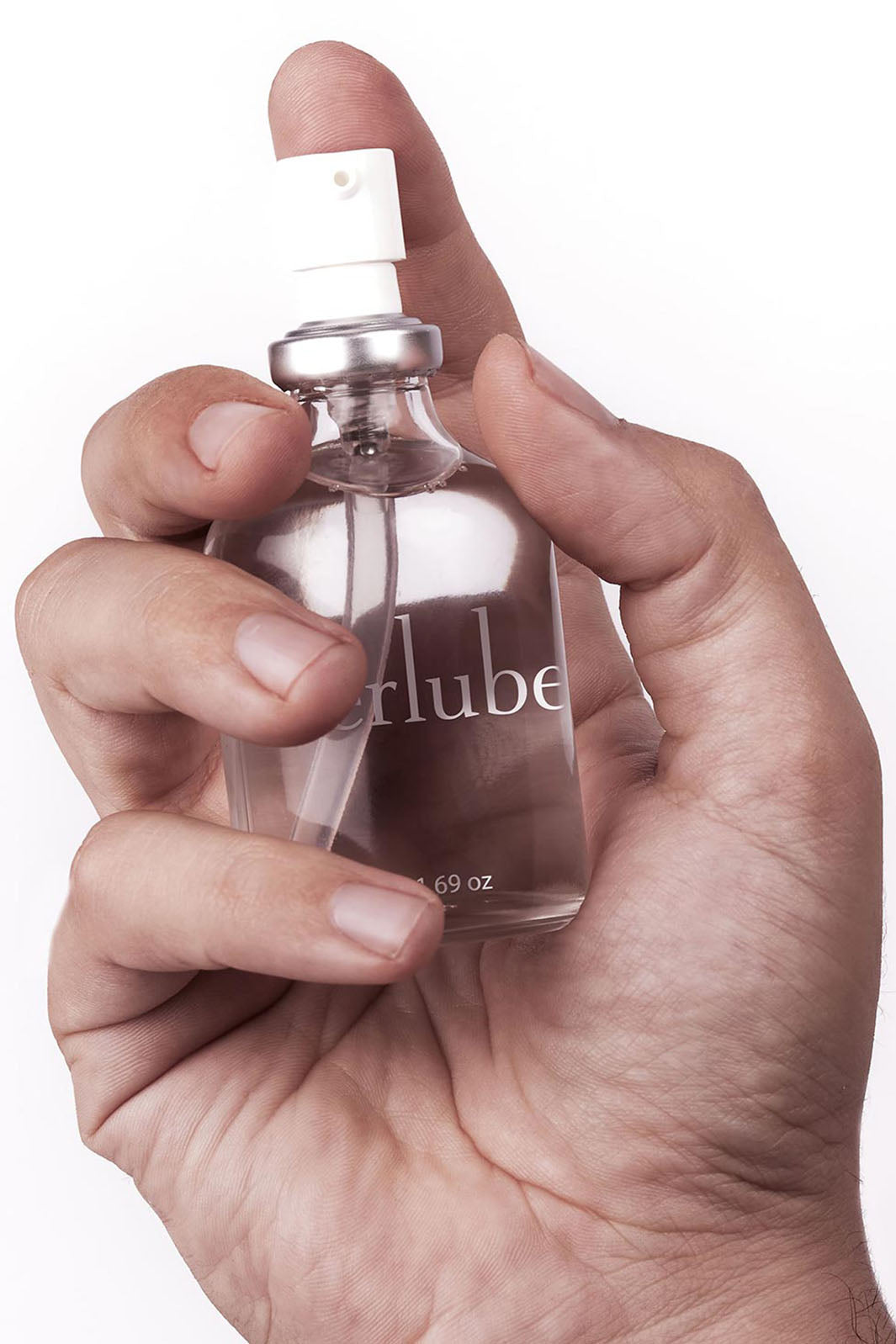 A hand holding the 55ml glass pump bottle of Uberlube, a lubricant for sex, style, and sport. 
